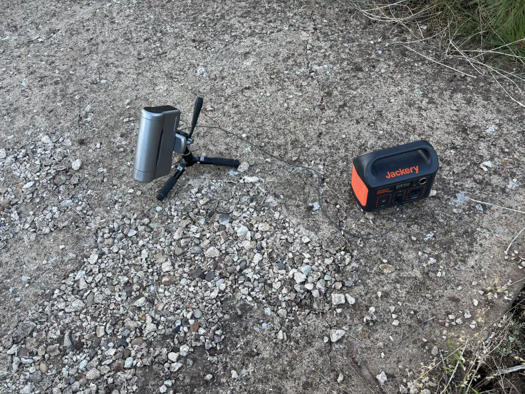 photo of a telescope and battery in a field