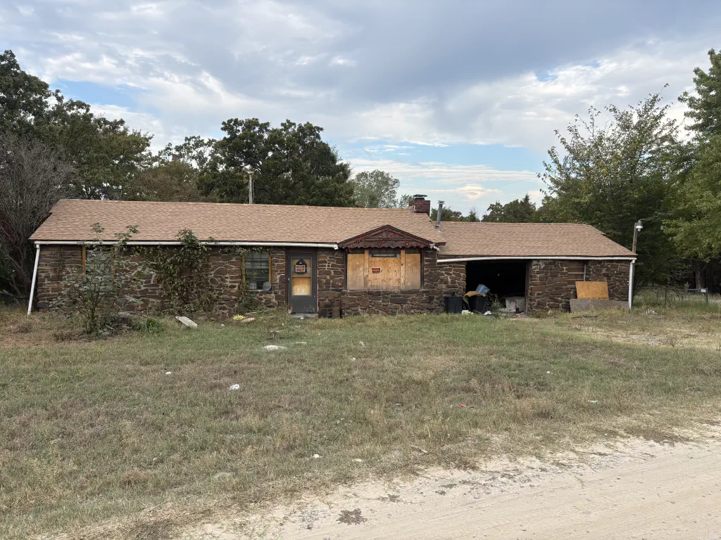 photo of a house with its windows boarded up